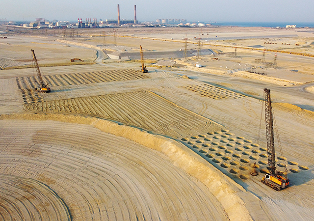 Six Bauer MC 96 duty-cycle cranes operate under extreme desert conditions at the Sabah Al Ahmad Sea City construction site.